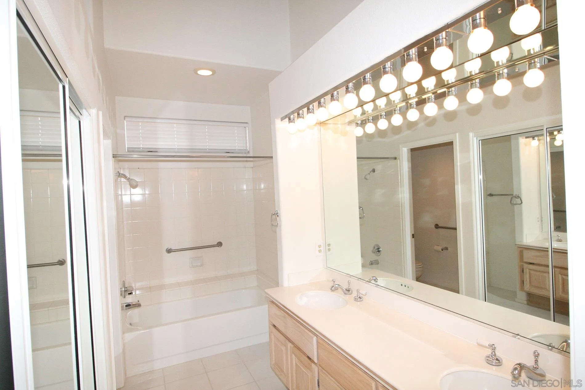 4190 Rhodes Way Oceanside, CA 92056 - Photo 15 of 25 a bathroom with a double vanity sink mirror and shower