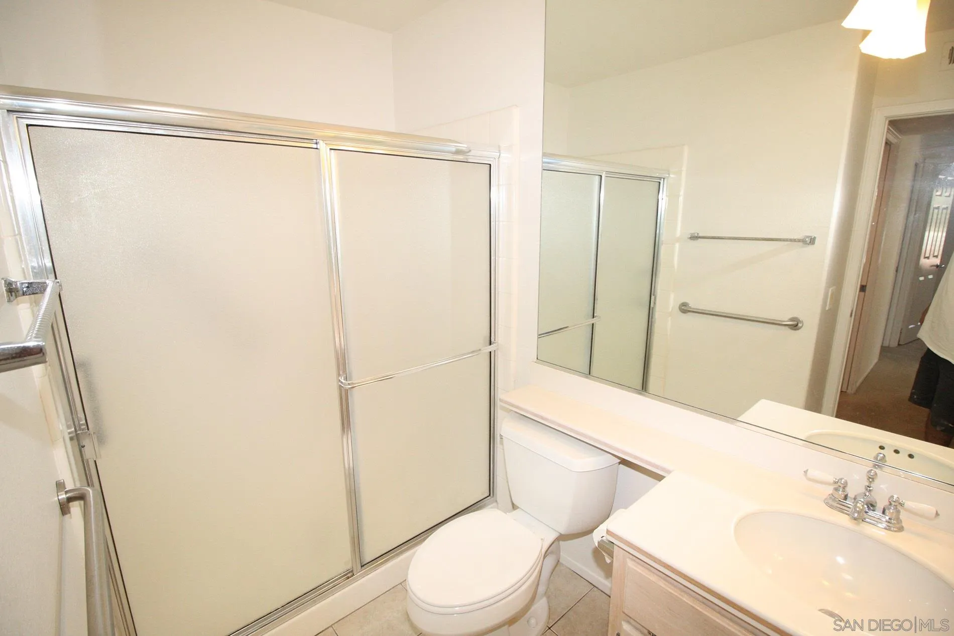 4190 Rhodes Way Oceanside, CA 92056 - Photo 17 of 25 a bathroom with a sink a toilet and shower