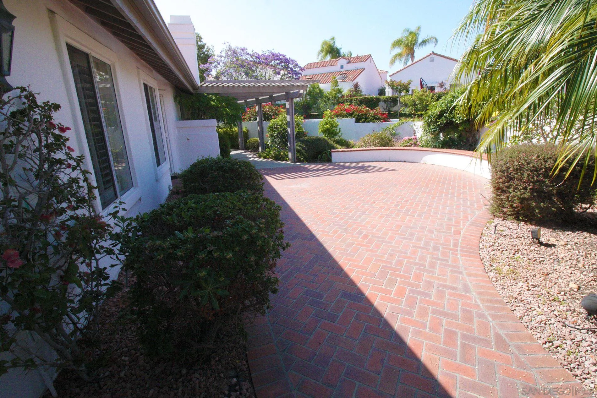 4190 Rhodes Way Oceanside, CA 92056 - Photo 3 of 25 a view of a garden with a pathway