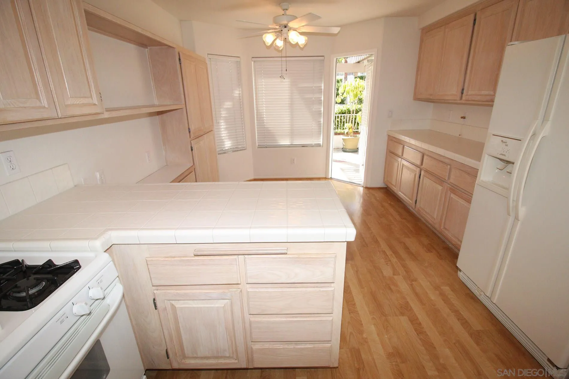 4190 Rhodes Way Oceanside, CA 92056 - Photo 10 of 25 a kitchen with a sink stove and cabinets