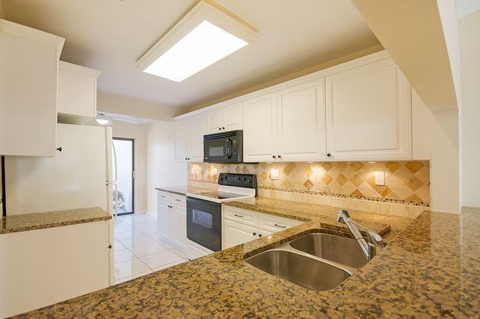 6839 Consolata Street Boca Raton, FL 33433 - Photo 4 of 20 kitchen with stone backsplash