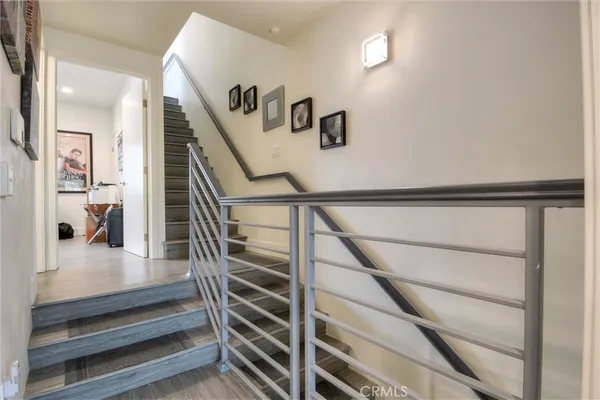 a living room with furniture a flat screen tv and kitchen view
