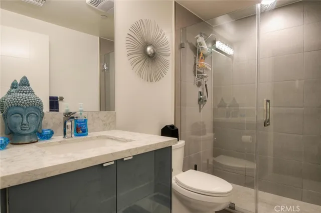 a bedroom with a bed and painting on the wall