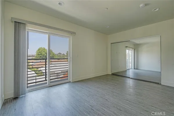 a bathroom with a granite countertop sink a toilet and a window