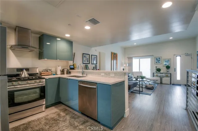 a kitchen with stainless steel appliances granite countertop a stove and a sink