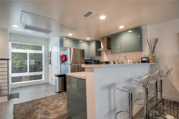 a bathroom with a granite countertop sink toilet and mirror