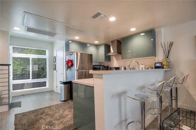 a bathroom with a granite countertop sink toilet and mirror