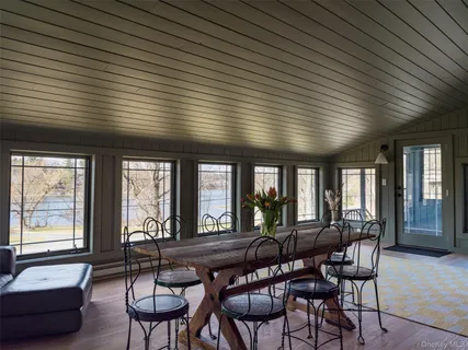a view of a dining room with furniture and windows