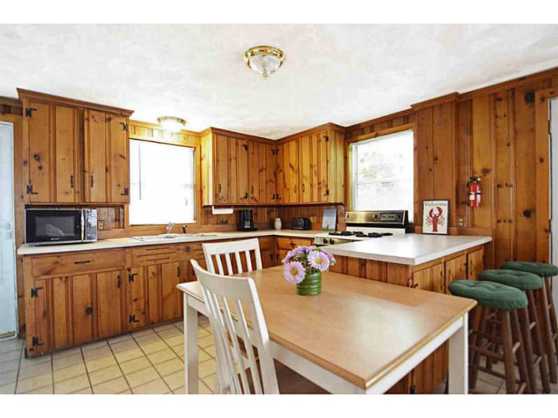 23 Angell Road Narragansett, RI 02882 - Photo 7 of 20 Kitchen. This generous sized kitchen comes fully applianced. Notice the door on the left of photo that leads to the outside deck. Ceiling was replaced in 2005.