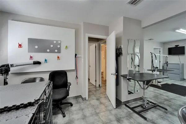 a view of a workspace with furniture and a window