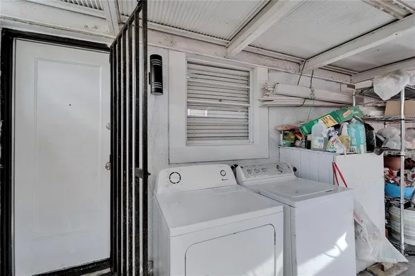 a view of a patio with table and chairs under an umbrella