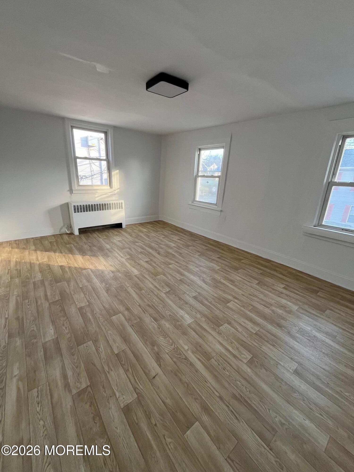 11 Main Street, Unit B New Egypt, NJ 08533 - Photo 5 of 13 an empty room with wooden floor and windows