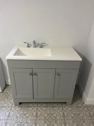 a bathroom with a sink and cabinets