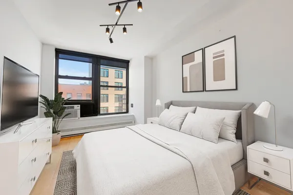 a bed room with a bed and a view of bedroom