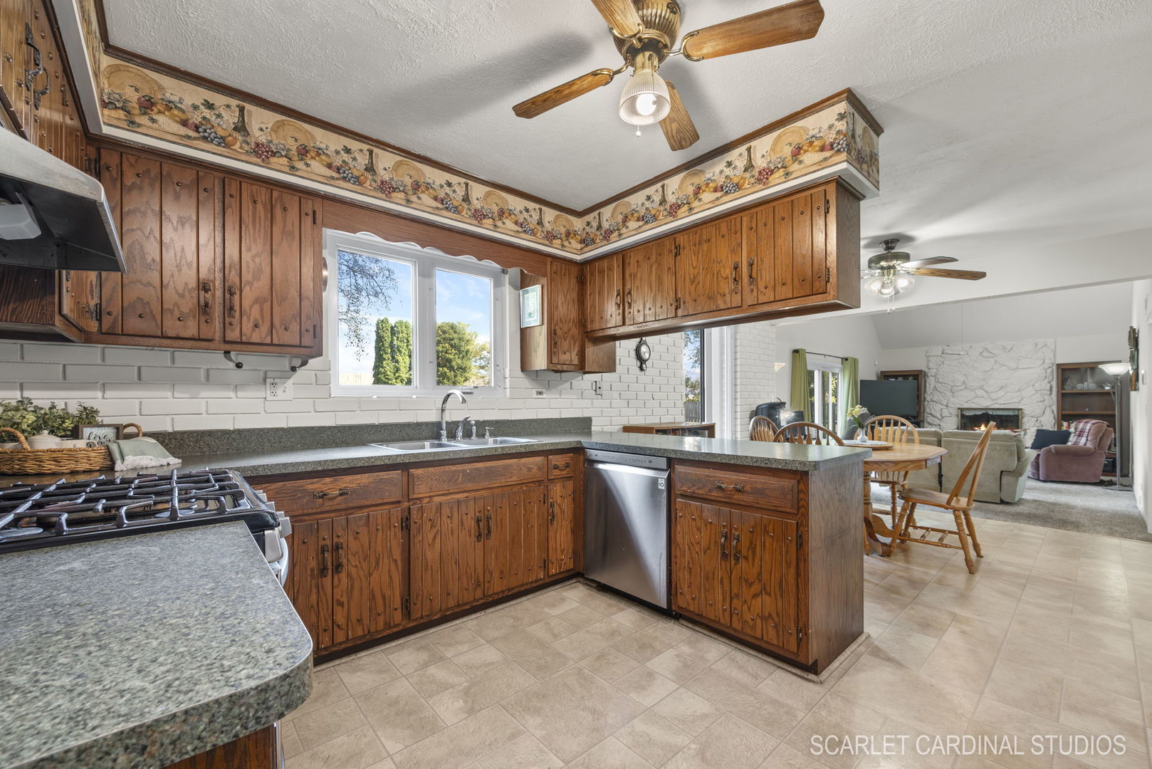 29W206 Wagner Road Naperville, IL 60564 - Photo 9 of 27 a kitchen with stainless steel appliances granite countertop wooden cabinets a dining table and chairs