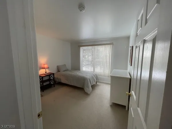 a spacious bedroom with a bed and a window