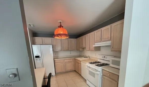 a kitchen with stainless steel appliances a refrigerator sink and cabinets
