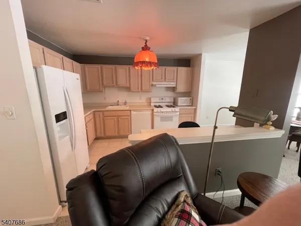 a kitchen with a refrigerator and a sink