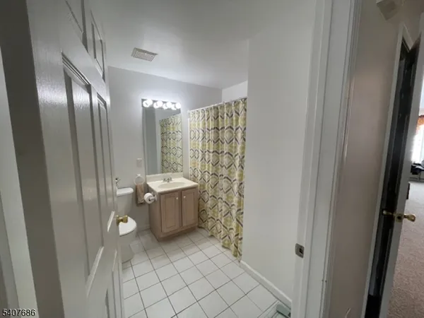 a bathroom with a sink mirror and shower
