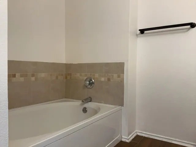 a bathroom with a tub and a shower