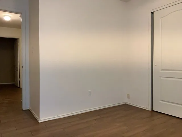 an empty room with wooden floor