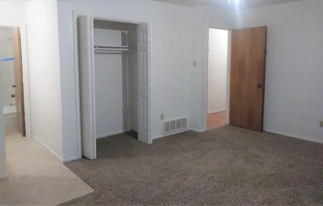 an empty room with closet area