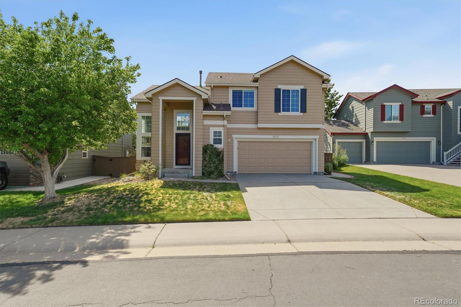 9629 Burberry Way Highlands Ranch, CO 80129 - Photo 2 of 50 a front view of a house with a yard and garage
