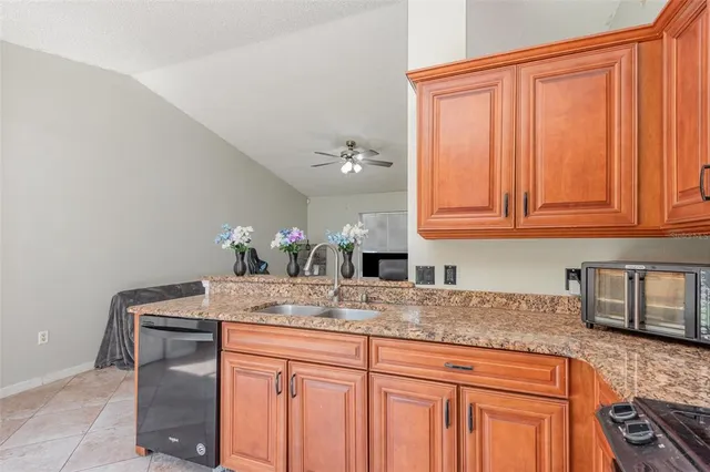 a kitchen with stainless steel appliances granite countertop a sink and cabinets