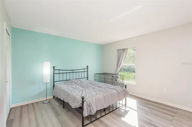 a bed sitting in a bedroom next to a window