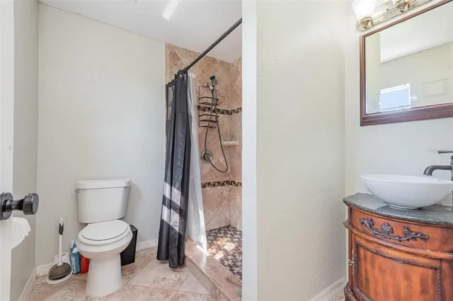 a bathroom with a toilet and a shower