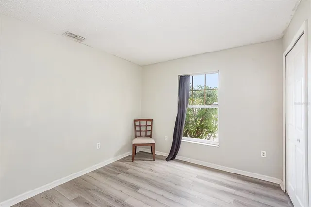 an empty room with windows and closet