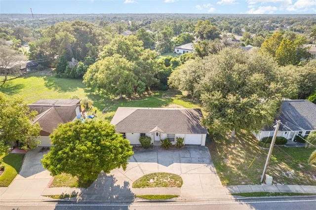 an aerial view of a house with yard swimming pool and outdoor seating