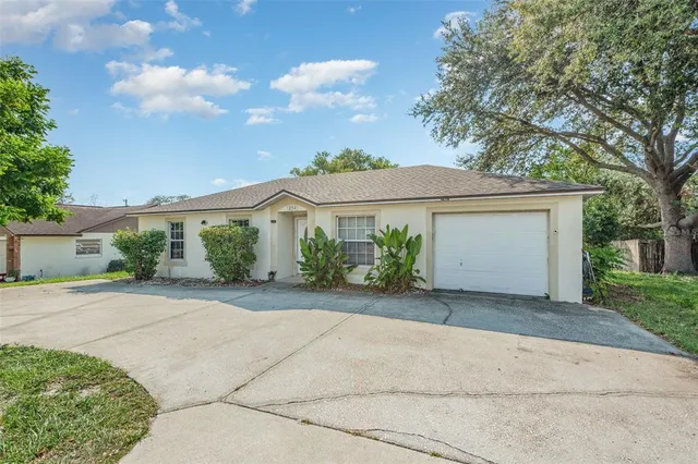 a front view of a house with a yard and a garage