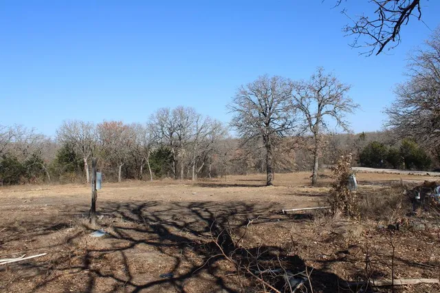 a backyard of a house with large trees