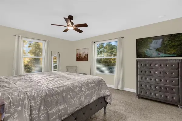 a bathroom with a granite countertop sink toilet a mirror a vanity and shower