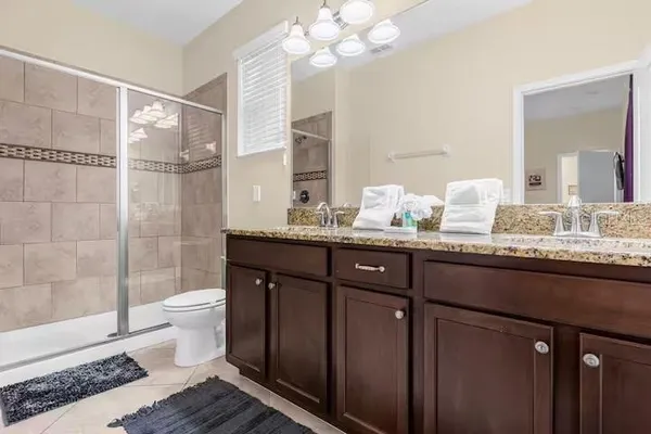 a bedroom with a bed and ceiling fan