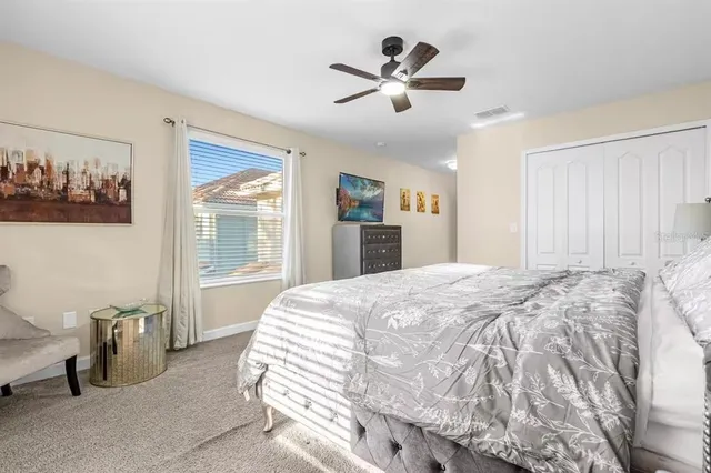 a bedroom with a bed and a window