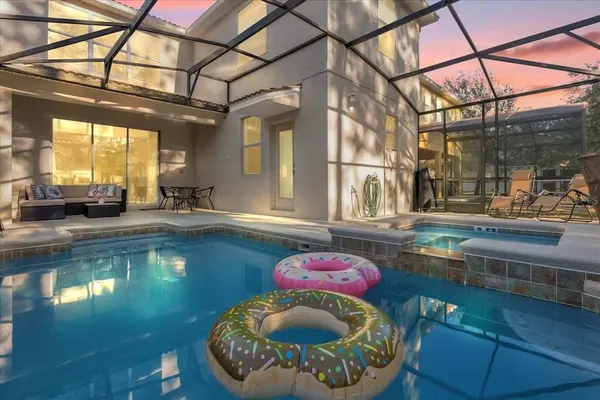 a view of a swimming pool with a dining table and chair