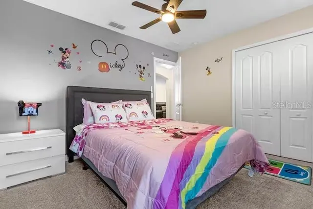 a bathroom with a granite countertop toilet sink and mirror