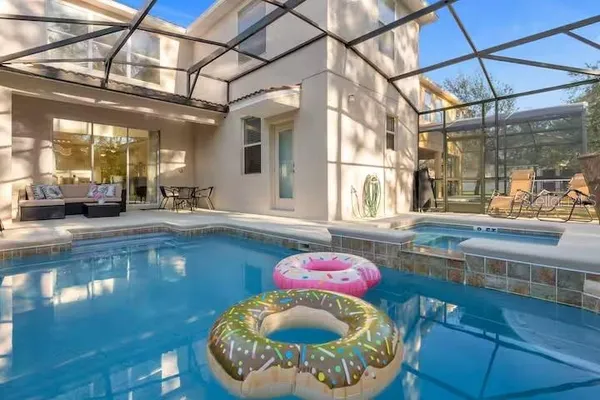 a view of a backyard with swimming pool