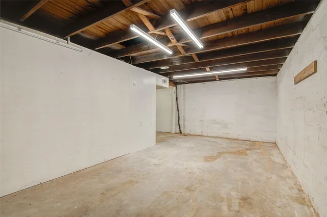 a front view of a house with cars parked