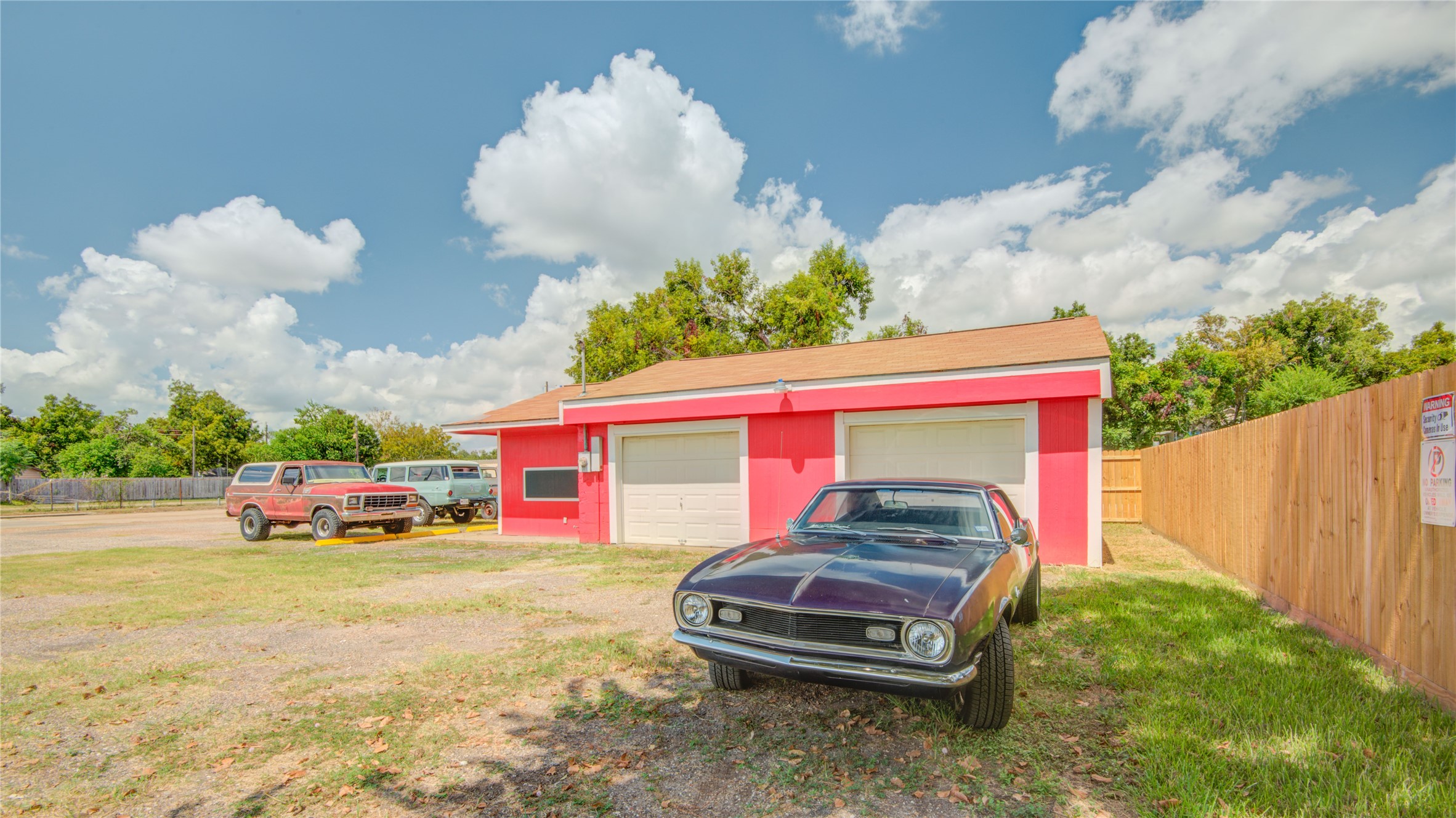 327 South Main Street Clute, TX 77531 - Photo 22 of 31 a car parked in front of a house with wooden fence