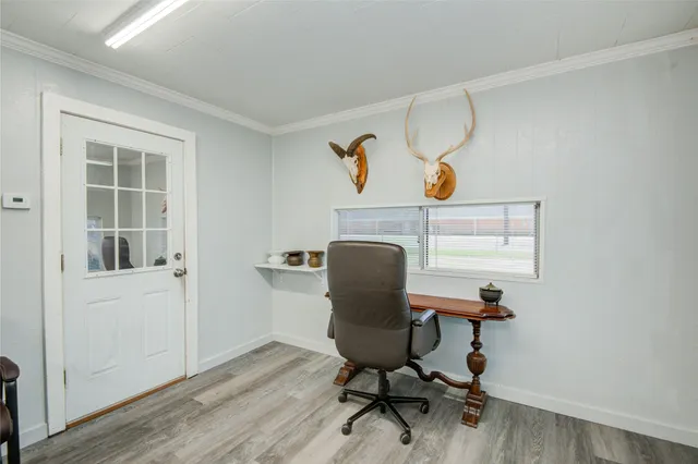 a view of a dining room with furniture and a window
