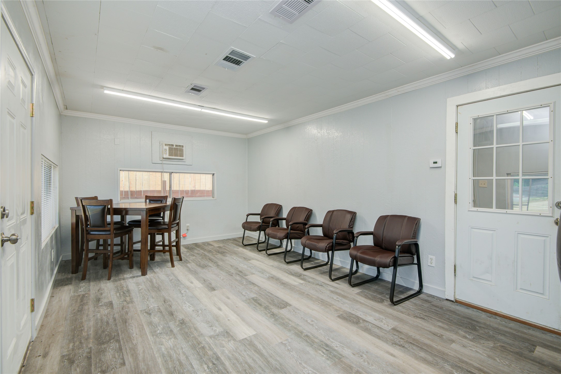 327 South Main Street Clute, TX 77531 - Photo 4 of 31 a dining room with furniture wooden floor a rug and a painting