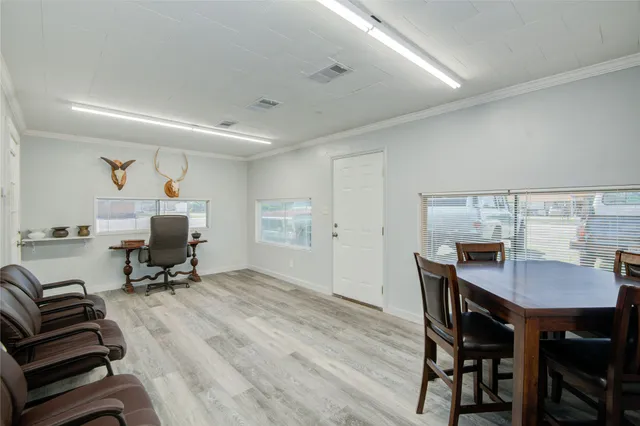 a workspace with furniture and a wooden floor