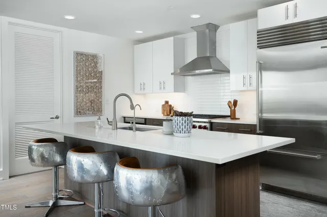 a view of a patio with couches and table and chairs and potted plants