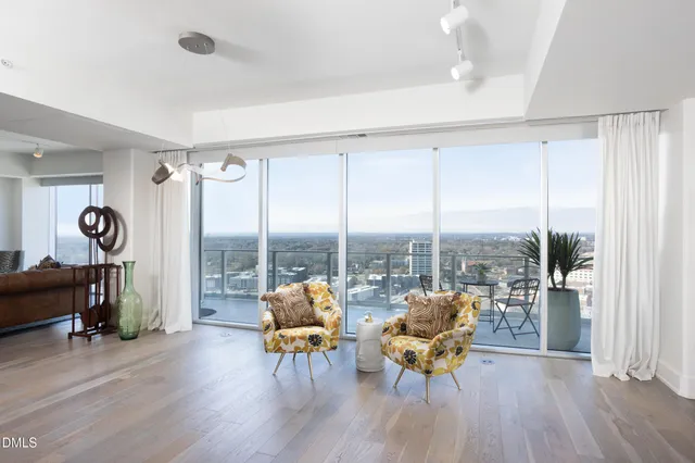 a kitchen with stainless steel appliances granite countertop a sink a stove and chairs