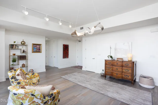 a en suite bathroom with a granite countertop double vanity and mirror