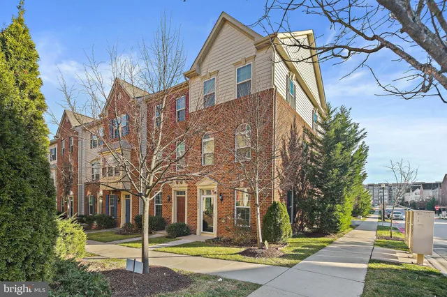 a view of a white house with a yard