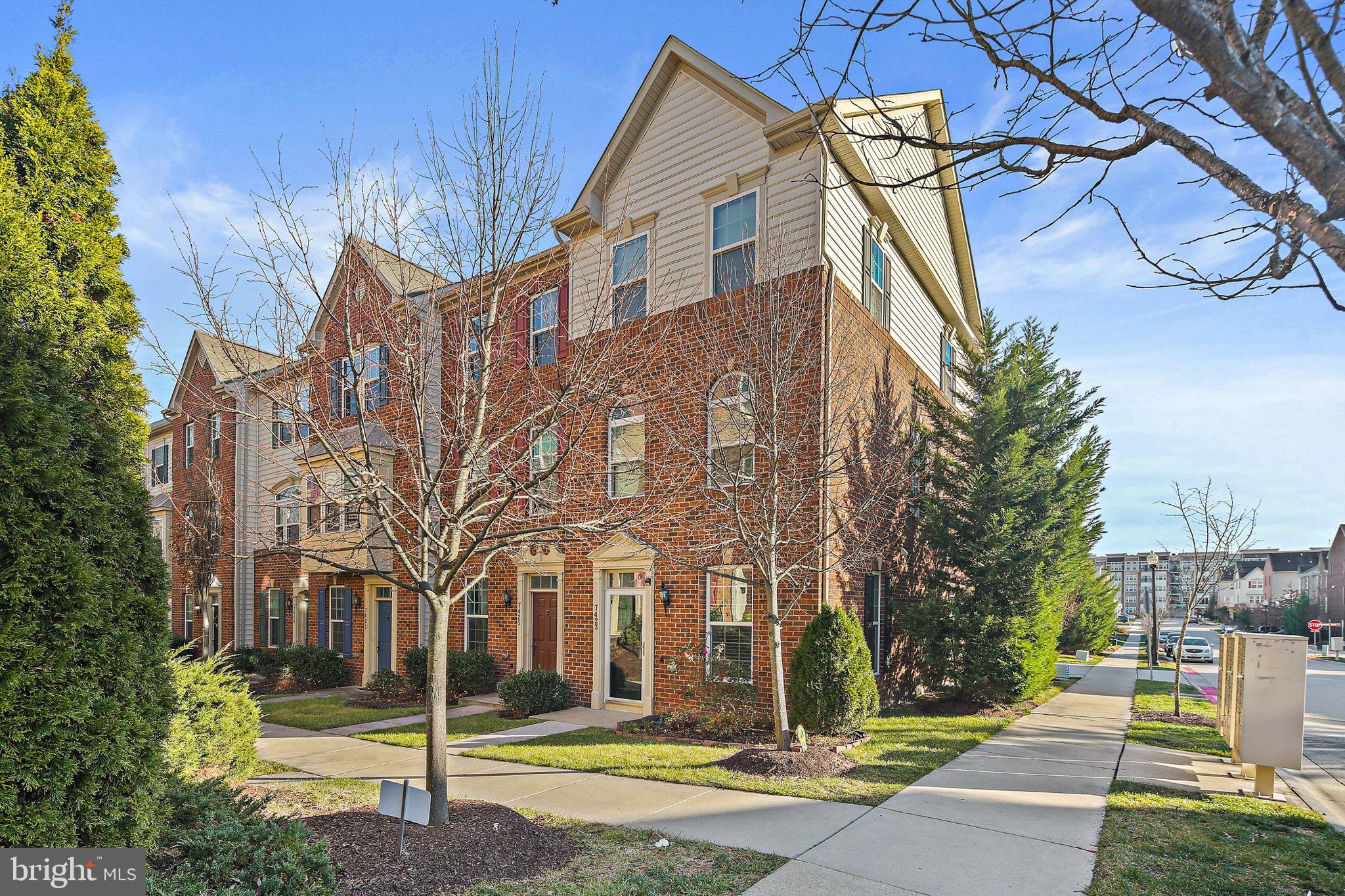 a view of a white house with a yard